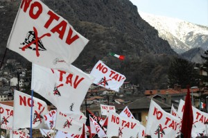 Flags printed with "NO TAV" are held up
